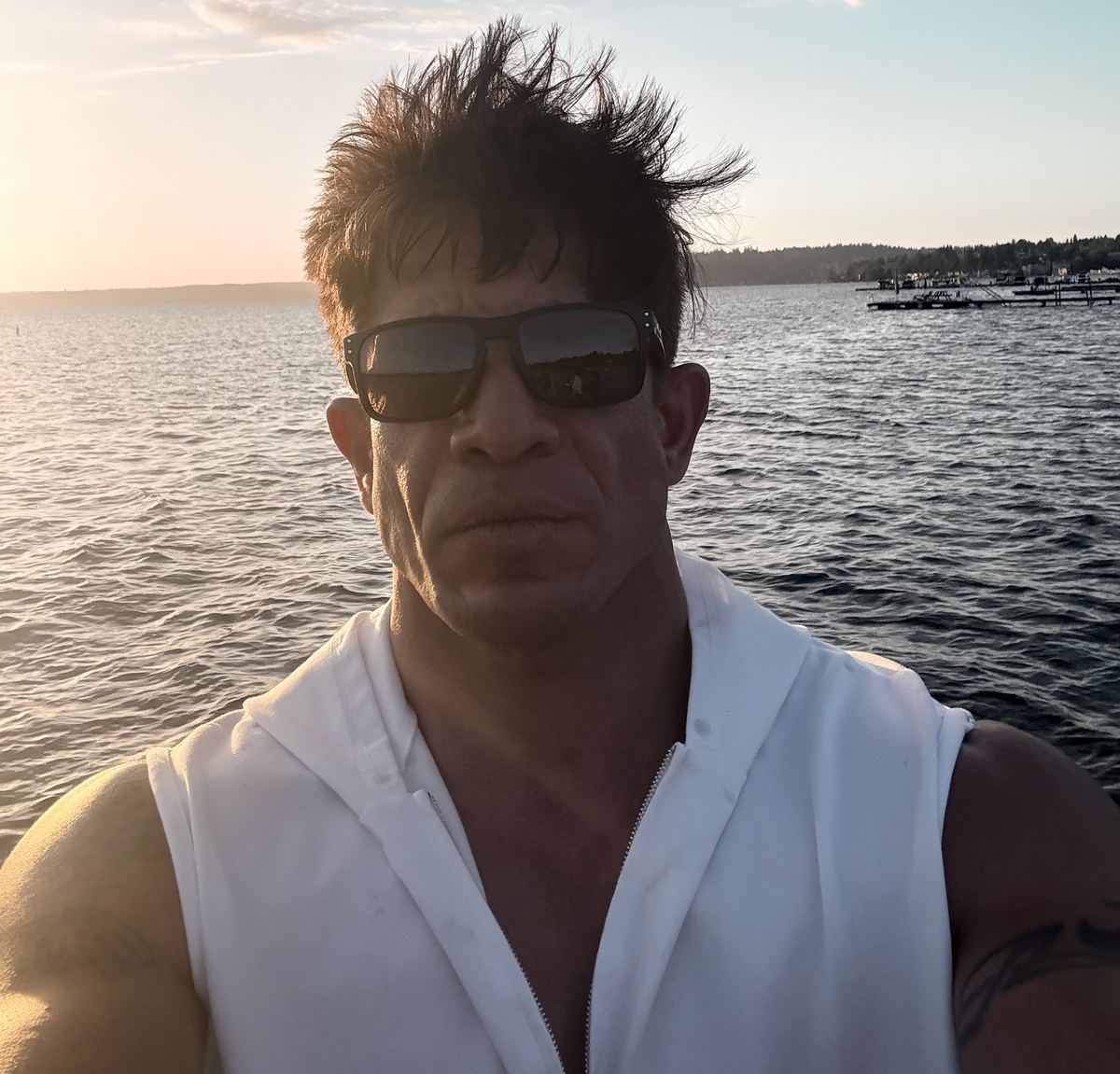 Michael Schatz, founder of The Liar, at the water's edge at sunset